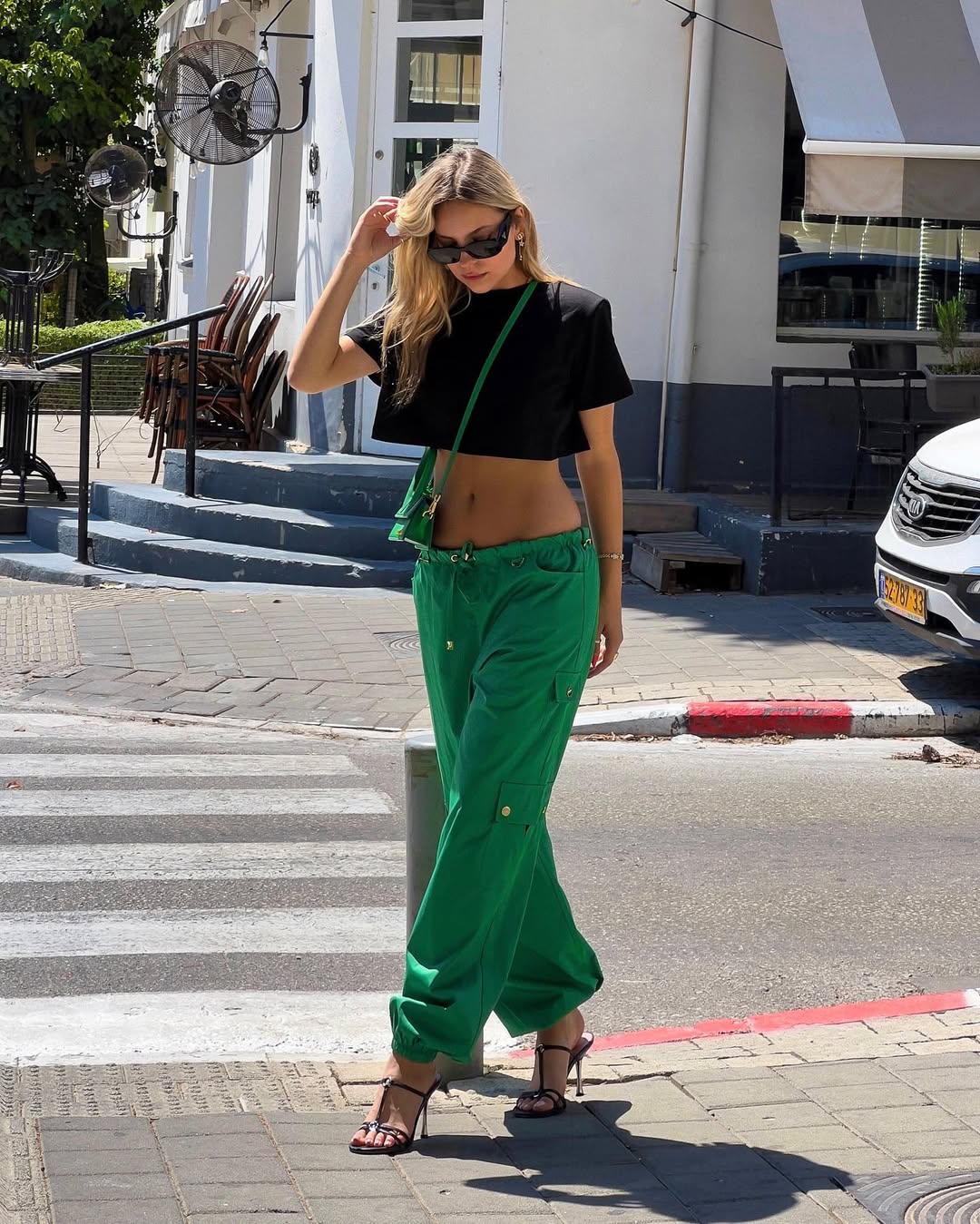 Bold green pants paired with a cropped black top