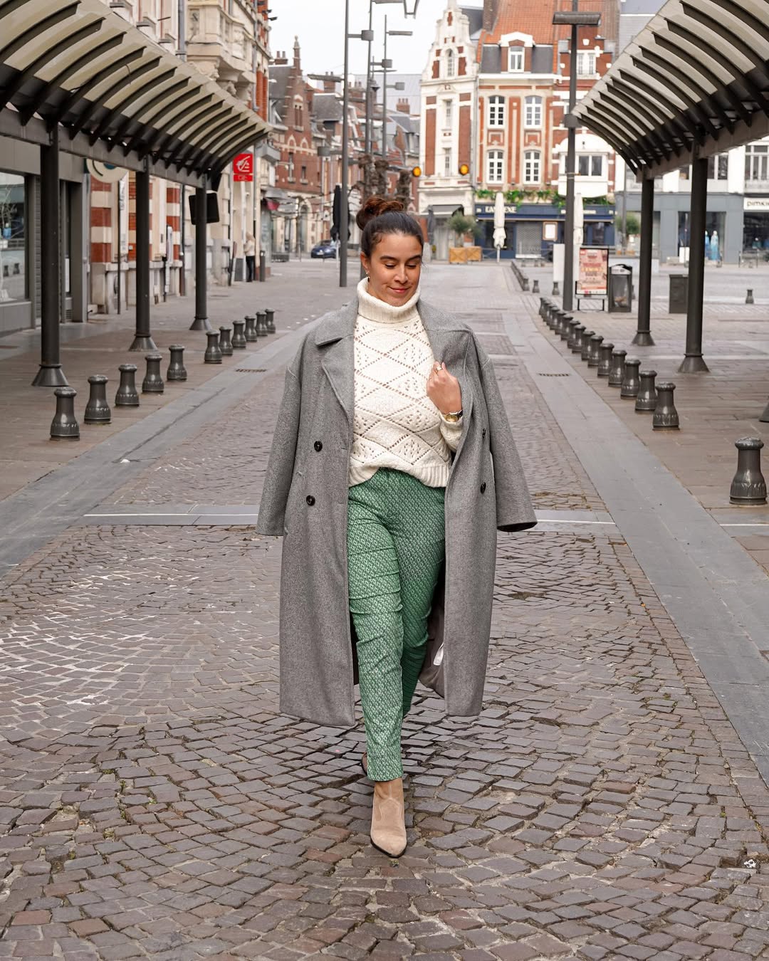 Chic winter layering with green pants and sweater