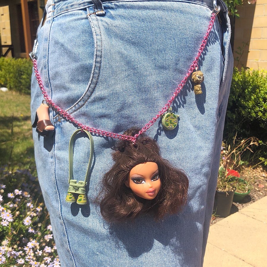 Playful doll chain adorns denim fit